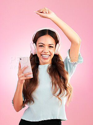 Buy stock photo Music headphones, phone and portrait of woman in studio isolated on a pink background. Smile, radio dance and happy female with mobile streaming, enjoying and listening to audio, sound or podcast.