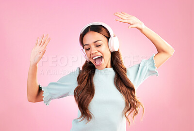 Buy stock photo Music headphones, dancing and woman singing in studio isolated on a pink background. Singer, radio dance and happy mixed race female streaming, enjoying and listening to audio, sound track or podcast