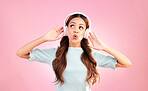 Music headphones, singing and woman whistle in studio isolated on a pink background. Singer, thinking and mixed race female streaming, enjoying and listening to audio, sound track or radio podcast.