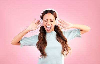 Buy stock photo Music headphones, singing and woman dance in studio isolated on a pink background. Singer, dancing and happy mixed race female streaming, enjoying and listening to audio, sound track or radio podcast