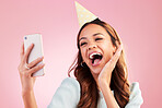 Birthday, selfie and excited with a woman in studio on a pink background for the celebration of an event. Phone, social media and party with an attractive young female celebrating a special occasion
