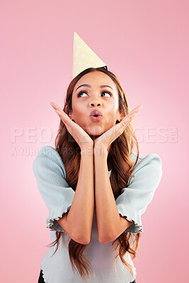Buy stock photo Birthday woman, studio and blowing kiss for celebration event, congratulations or celebrate happiness. Emoji gesture, party hat and relax female, person or young model looking on pink background