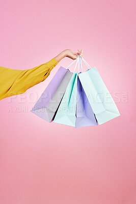 Buy stock photo Shopping bag, studio and hands of woman, person or female with retail sales product, discount deal or mall store present. Market choice purchase, luxury designer gift and customer on pink background