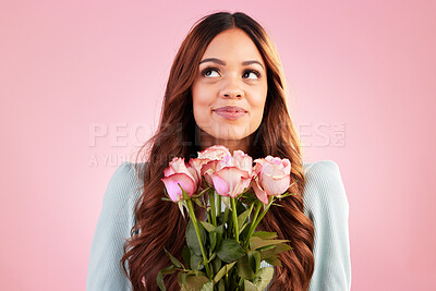 Buy stock photo Happy, thinking and female with roses in a studio for valentines day, romance or anniversary. Happiness, smile and young woman model from Mexico with a bouquet of flowers isolated by pink background.