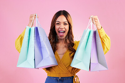 Buy stock photo Woman excited about shopping purchase, paper bag and retail, happy in portrait on pink background. Cheers, excitement about discount and promotion, fashion product and female with smile in studio 
