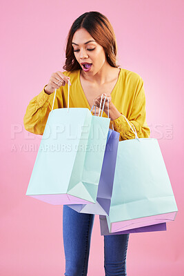 Buy stock photo Woman, shopping bag and wow sale in studio with a customer happy about promotion or discount. Female model or shopper on a pink background for fashion, brand and gift or surprise in paper bags