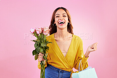 Buy stock photo Happy, shopping bags and flowers with woman in studio for retail, birthday and spring. Event, party and celebration with female customer and roses on pink background for sale, discount and romance