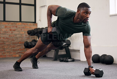 Buy stock photo Black man, dumbbell row and training in gym, workout and strong fitness in health club. Serious sports athlete, bodybuilder and weight exercise on ground for energy, power and core strength challenge