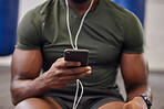Phone, music and man hands in gym for workout, search social media and online training podcast. Closeup sports person, smartphone and listening with earphones on mobile, exercise app and connection