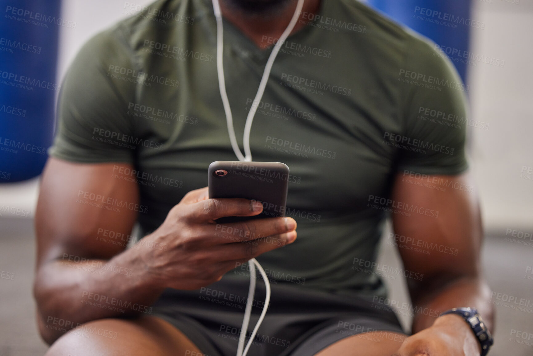 Buy stock photo Phone, music and man hands in gym for workout, search social media and online training podcast. Closeup sports person, smartphone and listening with earphones on mobile, exercise app and connection