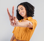 Happy, peace sign and portrait of woman in studio for positive, agreement and support. Thank you, yes and emoji with female isolated on gray background for achievement, confident and thank you