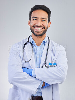 Doctor, man and portrait in a studio with a smile from success, motivation and stethoscope. Happiness, medical consultant and hospital worker with gray background smiling about health and wellness