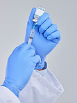 Vaccine vial, needle and doctor hands in studio for safety, healthcare and pharmaceutical medicine. Closeup, vaccination and injection bottle for virus risk, immunity and medical antibiotics drugs 