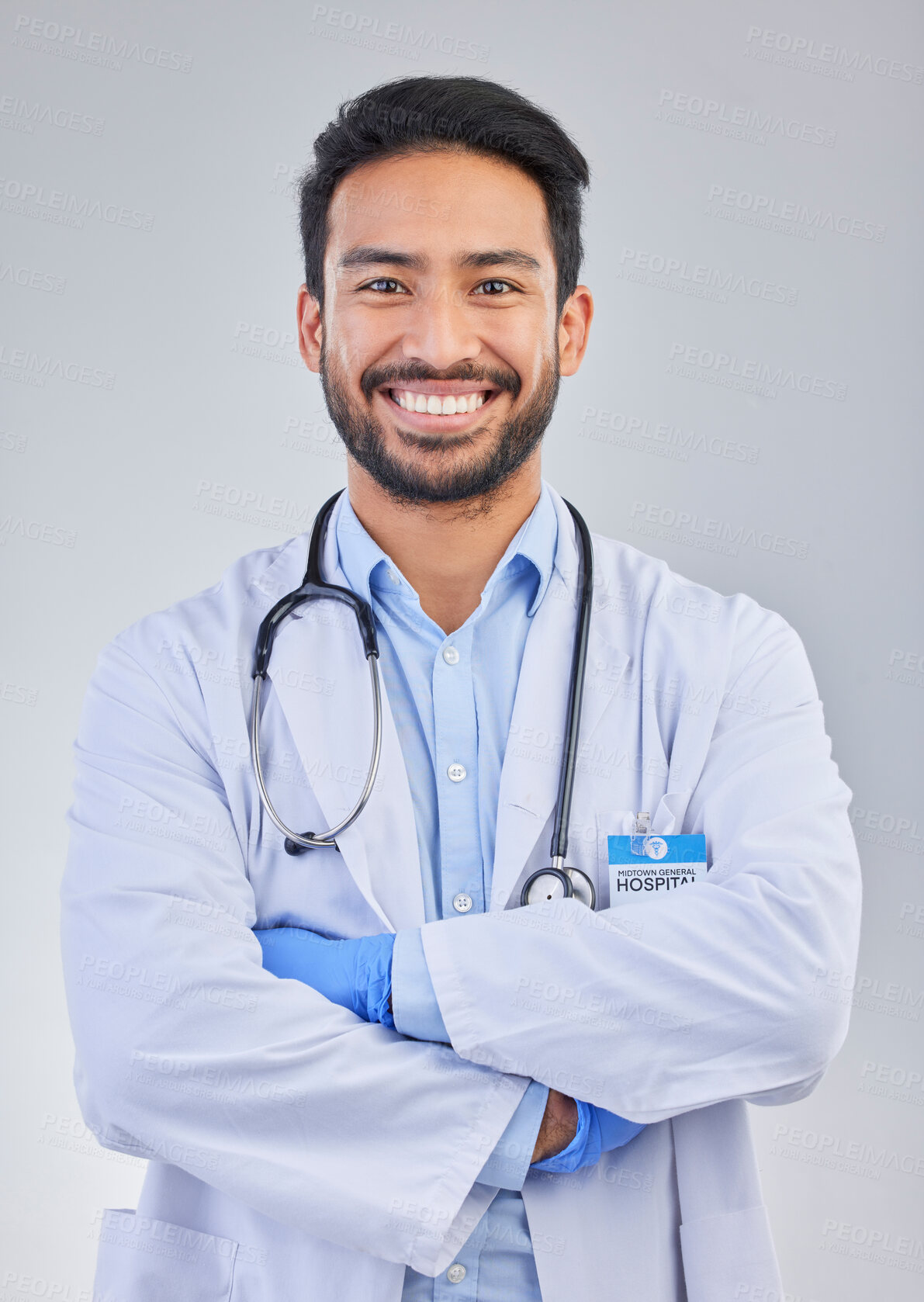 Buy stock photo Doctor, happy man and portrait in a studio with a smile from success, motivation and stethoscope. Happiness, medical consultant and hospital worker with gray background smiling about health vision