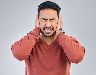 Buy stock photo Asian man, frustrated and cover ears in studio for sound noise, mental health and headache by gray background. Young student guy, panic attack or anxiety with hands on head with anger, stress or fail