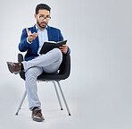 Human resources, questions and businessman with notebook for interview process in studio on grey background. Recruiter, asian male and recruitment process, negotiation and onboarding discussion