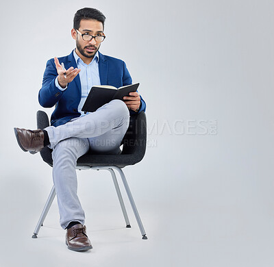 Buy stock photo Human resources, questions and businessman with notebook for interview process in studio on grey background. Recruiter, asian male and recruitment process, negotiation and onboarding discussion