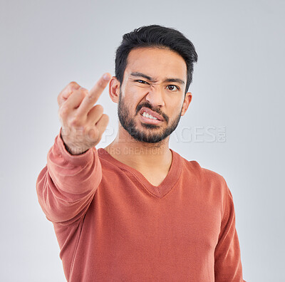 Buy stock photo Rude, middle finger and portrait of asian man in studio for fail, conflict and problem. Annoyed, upset and aggressive with male and hand gesture on gray background for hate, disrespect and furious