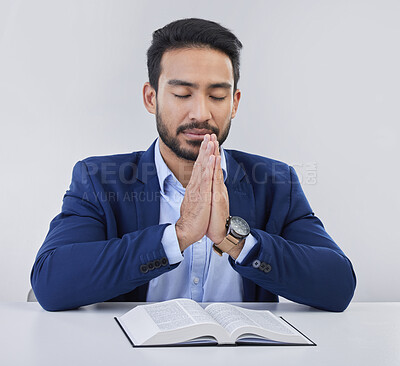 Buy stock photo Mockup, faith and Asian man, praying, bible and guidance against grey studio background. Japanese male, believer and Christian guy with holy book, prayer and hope for solution, religious or gratitude