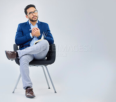 Buy stock photo Human resources, concentration and businessman with notebook for interview process in studio on grey background. Recruiter, asian male and recruitment process, negotiation and onboarding meeting