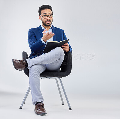 Buy stock photo Questions, human resources and businessman with notebook for interview process in studio on grey background. Recruiter, asian male and recruitment process, negotiation and onboarding discussion