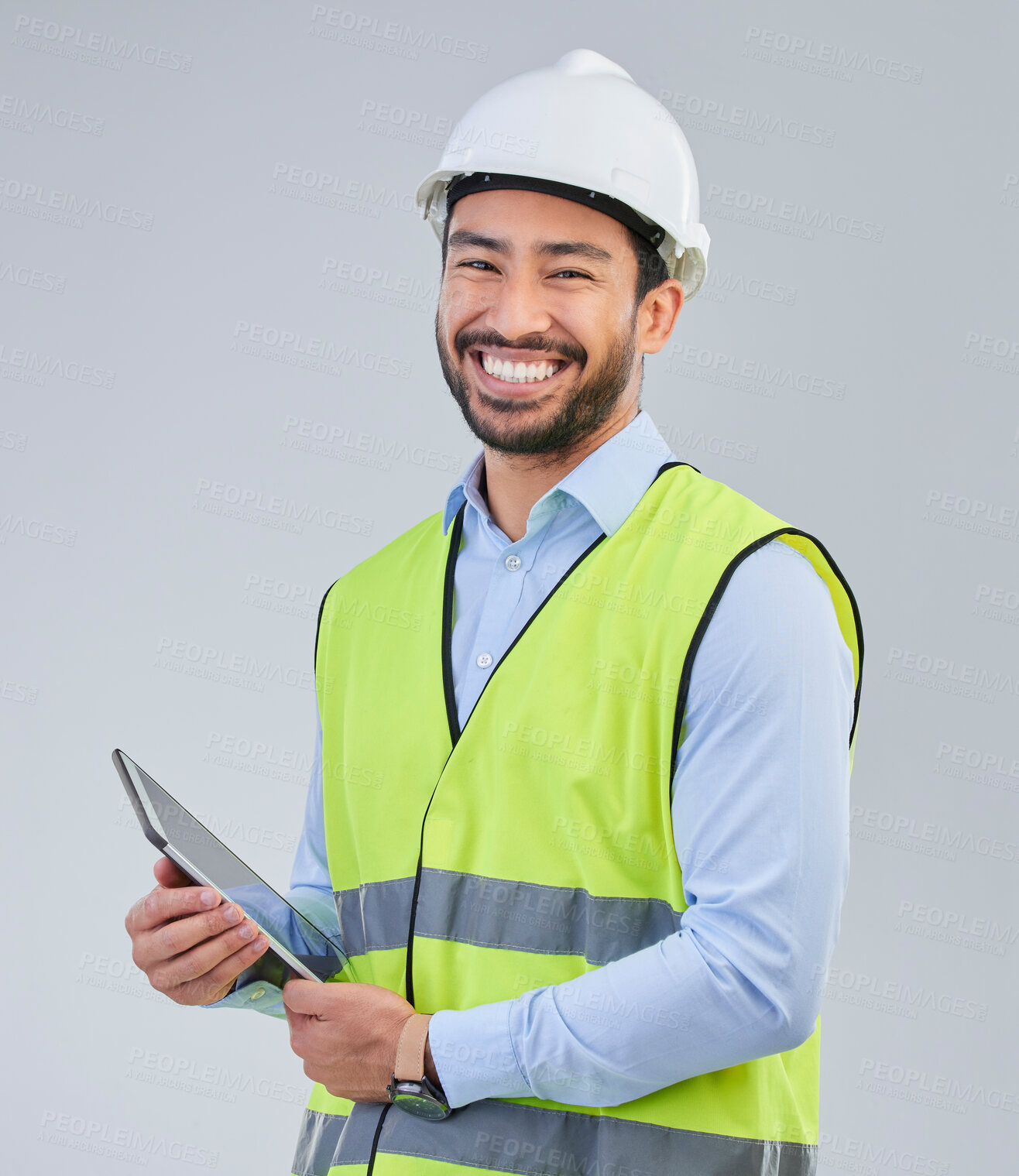 Buy stock photo Construction worker, portrait and happy man in studio with tablet and helmet safety on white background. Smile, internet and contractor or architect in online planning for project management in India
