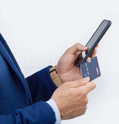 Buy stock photo Credit card, phone and hands of man in studio for online shopping, fintech and investment. Banking, ecommerce and app with male isolated on gray background for customer experience, payment and retail