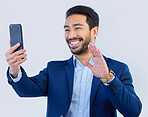 Smartphone, video call and asian businessman in studio with wave, talking and networking on white background. Phone, conversation and b2b communication and technology for investor trading at startup.