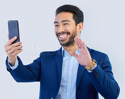 Buy stock photo Smartphone, video call and asian businessman in studio with wave, talking and networking on white background. Phone, conversation and b2b communication and technology for investor trading at startup.