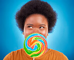 Sweet, happiness and black woman with lollipop, excited and lady on blue studio background. African American female, candy and girl with dessert, happy and cheerful with joy, treat and confectionary