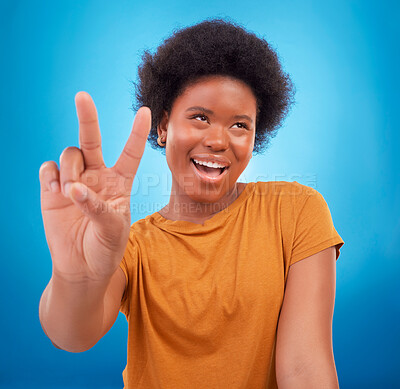 Buy stock photo Peace sign closeup, black woman hand and happiness with a young female smile. Isolated, blue background and v hands gesture of a happy African model with a afro and beauty feeling cool and fun