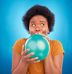 Balloon, happy and black woman in studio for celebration, good news or birthday on blue background. Party, blowing and girl with inflatable while celebrating, excited and having fun while isolated
