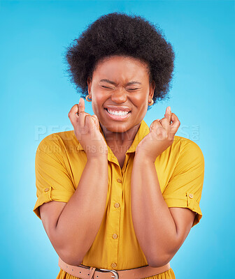 Buy stock photo Black woman, fingers crossed and hope in studio, blue background and hopeful face. Female model, wish and hands in lucky bonus, promotion and winning giveaway competition, emoji sign or lottery prize
