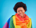 Rainbow, happy and black woman with lgbtq flag in studio for gay community, queer rights and homosexual pride. Free, smile and face of girl for lesbian, bisexual and trans support on blue background