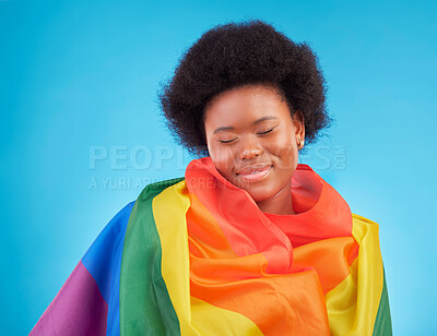 Buy stock photo Rainbow, happy and black woman with lgbtq flag in studio for gay community, queer rights and homosexual pride. Free, smile and face of girl for lesbian, bisexual and trans support on blue background
