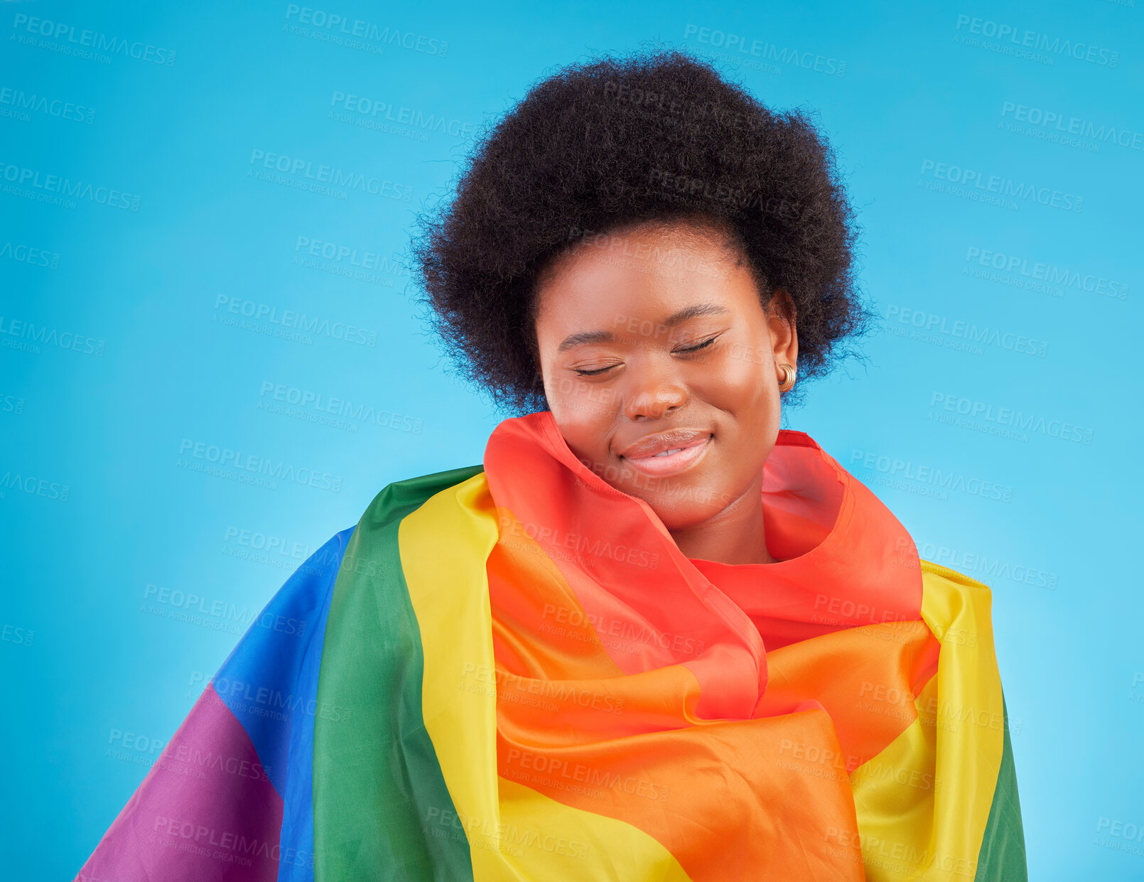 Buy stock photo Rainbow, happy and black woman with lgbtq flag in studio for gay community, queer rights and homosexual pride. Free, smile and face of girl for lesbian, bisexual and trans support on blue background