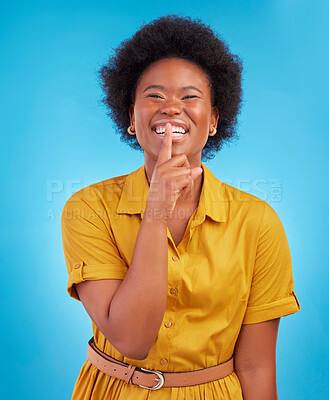 Buy stock photo Portrait, smile and secret with a black woman in studio on a blue background standing finger on lips. Gossip, whisper and mystery withan attractive young female making a hand gesture emoji of privacy