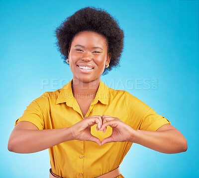 Buy stock photo Heart hands, happy black woman and portrait in studio, blue background and backdrop for hope. Female model smile for finger shape, love emoji and thank you of support, peace and care sign of kindness