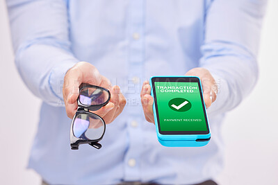 Buy stock photo Man, hands and phone with transaction approval or glasses for ecommerce or purchase against a white studio background. Hand of male holding spectacles and mobile smartphone for electronic payment