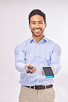 Portrait, phone and glasses with a man in studio on a gray background to offer a package deal for technology. Happy, smile with a male agent marketing while holding a wireless device and eyewear