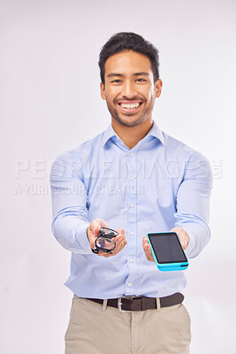 Buy stock photo Portrait, ecommerce and glasses with a man in studio on a gray background to offer pos payment for eye care. Happy, smile with an agent marketing while holding a wireless finance device and eyewear