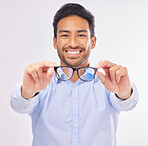 Glasses, vision portrait and man happy in studio for eye care, lens or frame isolated on a white background. Smile of asian male model show optometry eyewear brand in hands to check eyesight or focus