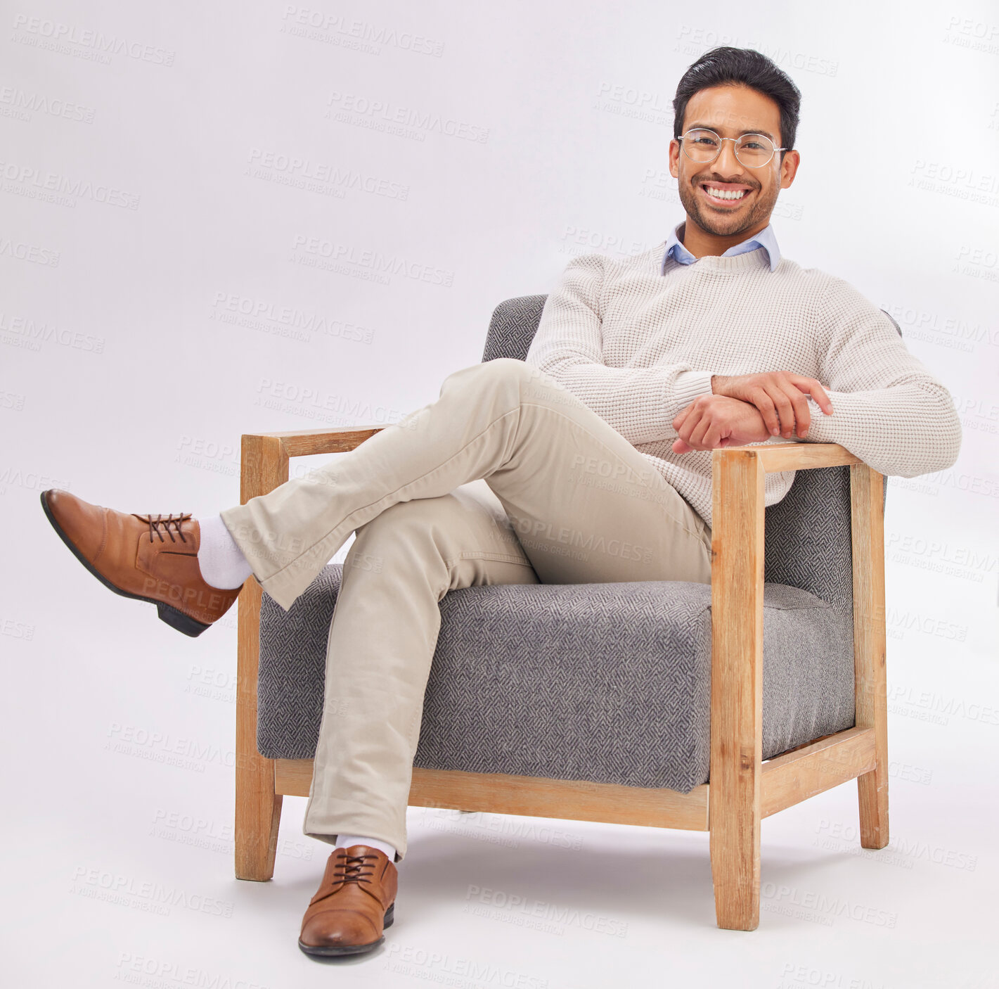 Buy stock photo Confident, chair and portrait of entrepreneur sitting happy with a smile and crossed legs isolated in studio white background. Gentleman, relax and professional or proud male employee or business man
