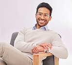 Vision, chair and portrait of businessman for optometry sitting happy with a smile and crossed legs isolated in studio white background. Glasses on face of professional male employee or entrepreneur