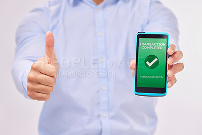 Buy stock photo Man, hands and phone with thumbs up for transaction approval against a white studio background. Hand of male showing thumb emoji, yes sign or like for electronic purchase or ecommerce on smartphone