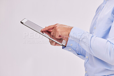 Buy stock photo Hands, tablet and business man typing in studio isolated on a white background. Technology, social media and male professional with touch screen for research, web scrolling and internet browsing.