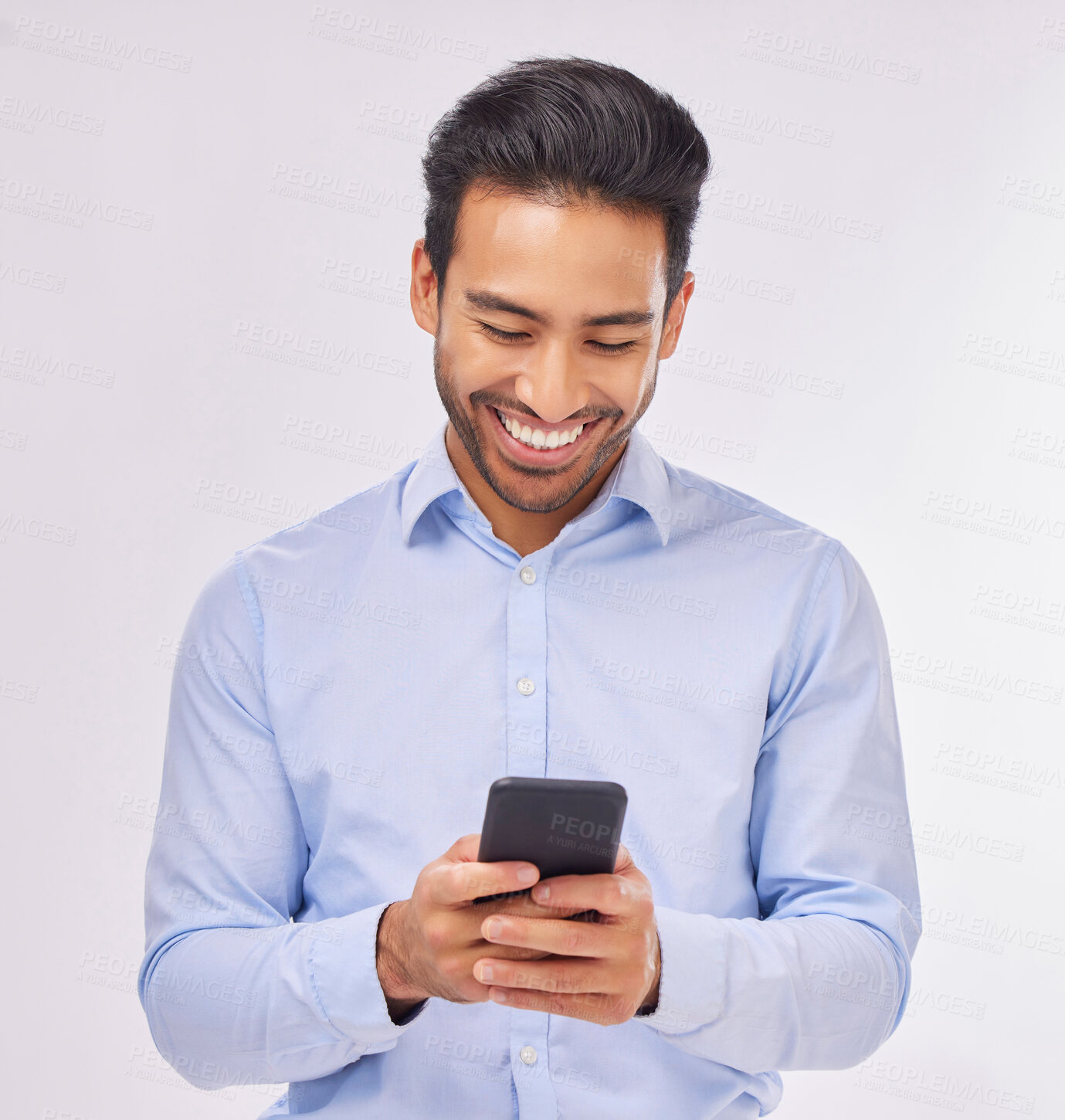Buy stock photo Smile, phone and business man typing in studio isolated on a white background. Cellphone, web networking and happy male professional with smartphone for reading, social media or mobile app online.