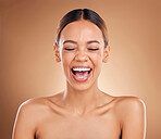 Beauty, face and a woman laughing in studio for skincare with dermatology, cosmetics or makeup. Happy aesthetic female model on a brown background for self care, skin glow and facial wellness