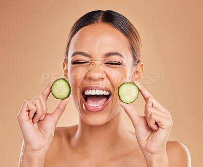 Buy stock photo Skincare, cucumber and face of woman with excited smile for wellness, facial treatment and natural cosmetics. Beauty, spa aesthetic and happy girl with fruit for detox, vitamin c and health in studio