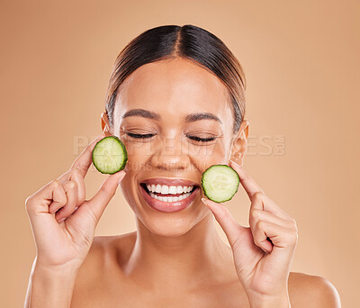 Buy stock photo Beauty, cucumber and face of woman with smile in studio for wellness, facial treatment and natural cosmetics. Skincare, dermatology spa and happy girl with fruit for detox, vitamin c and healthy skin